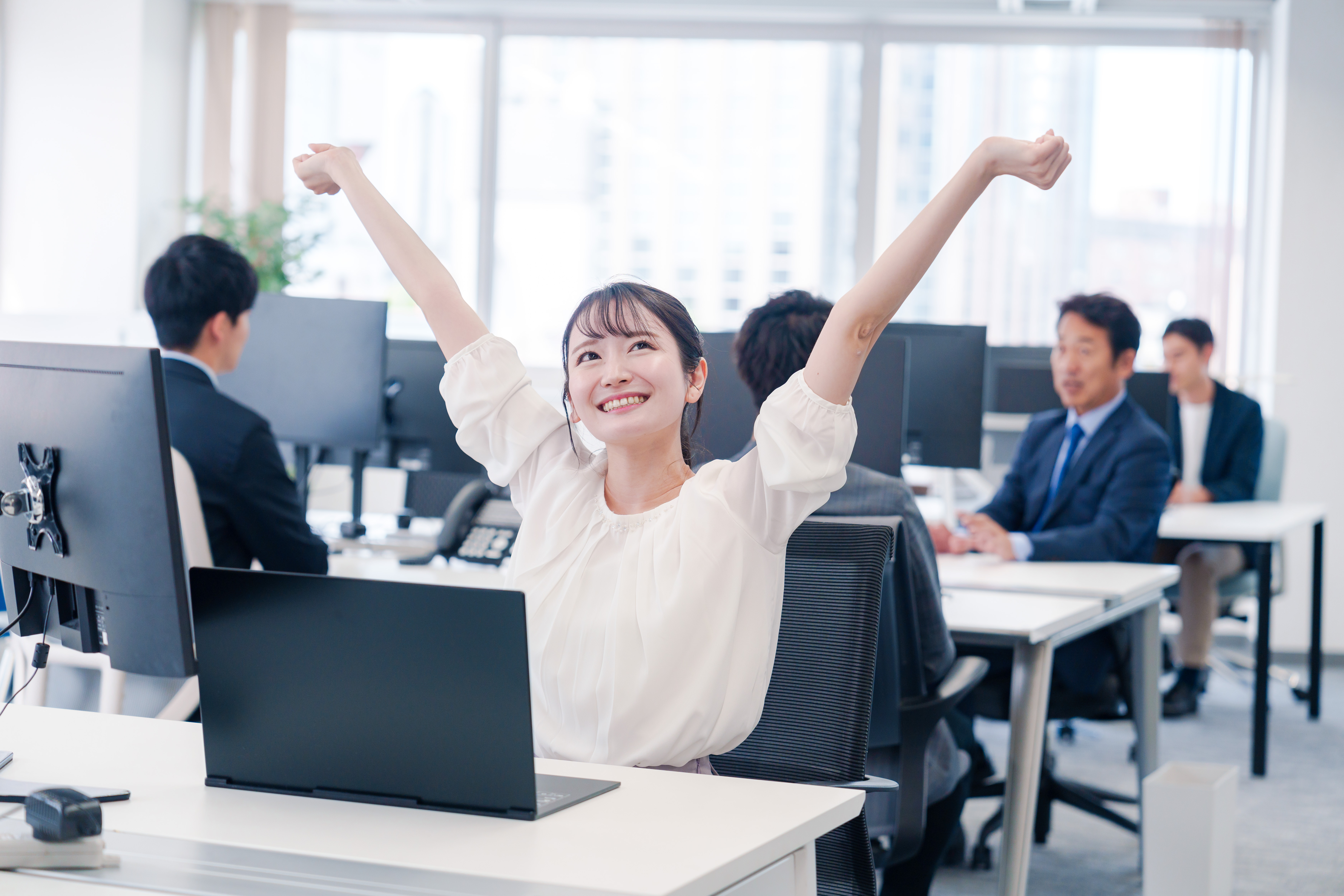 伸びをするオフィスワーカーの女性